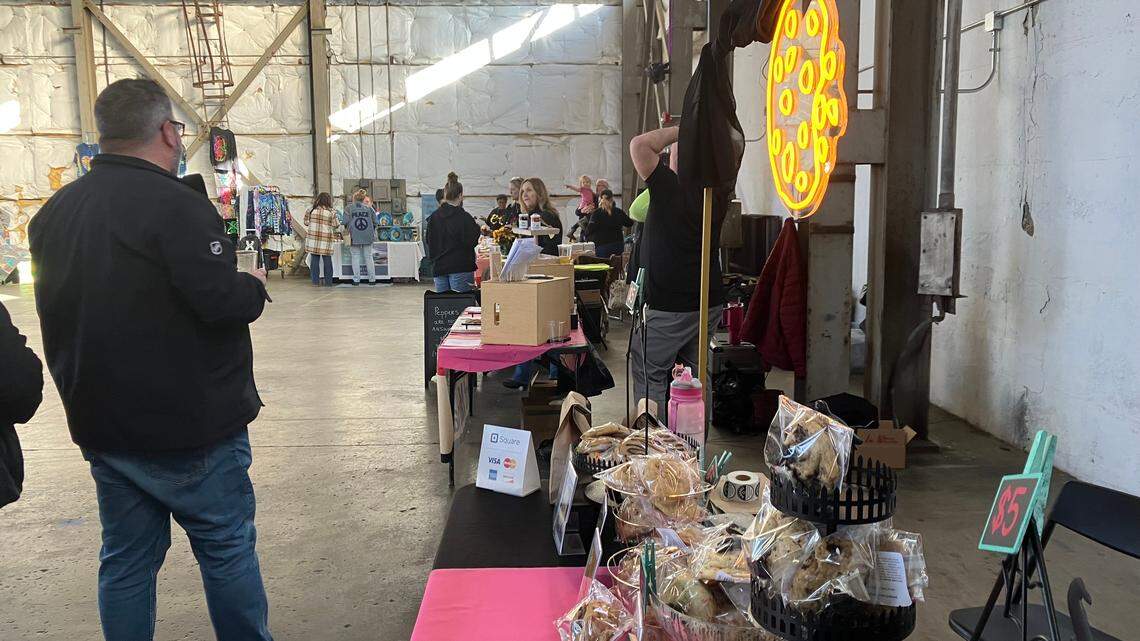 Vendors talk with attendees at the Night Market at Penguin City Brewing Company.