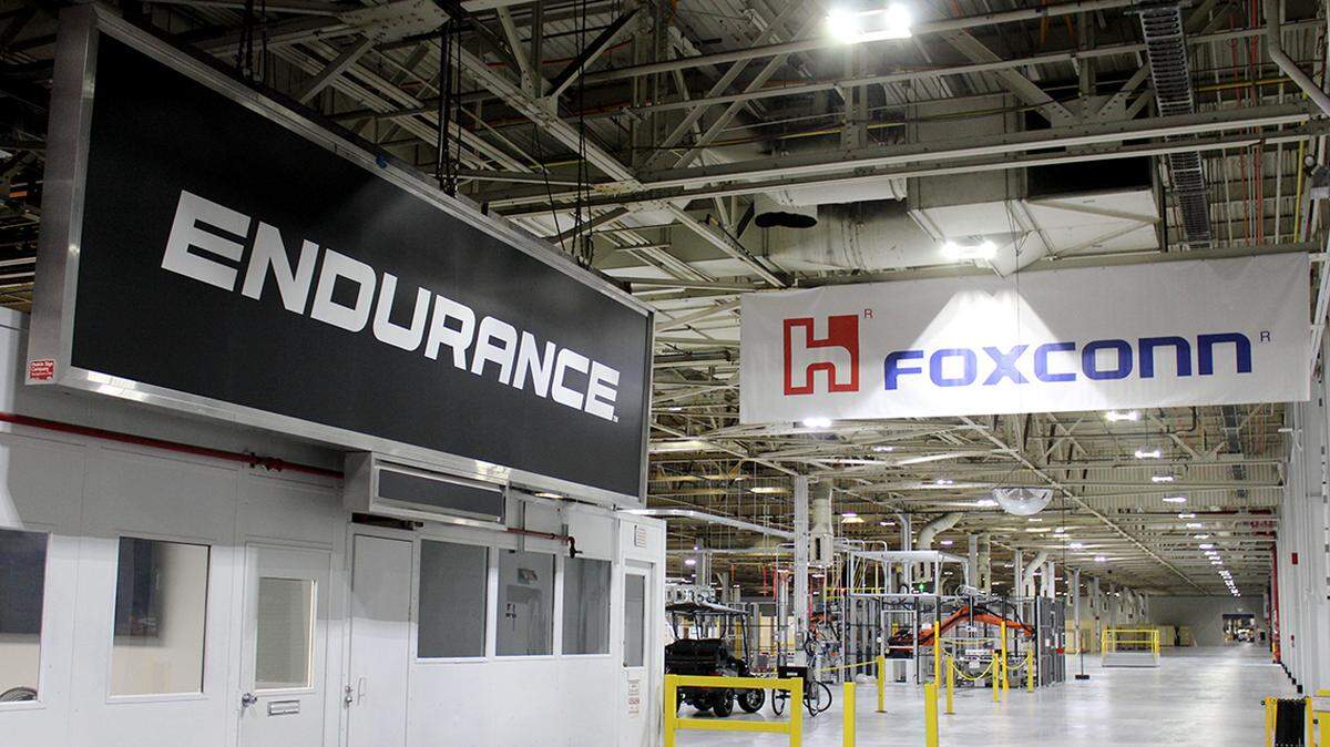 Signs for Lordstown Motors Corp.’s electric pickup truck, Endurance, and Foxconn Technology Group are shown side-by-side in Foxconn’s newly acquired automotive assembly plant along Hallock Young Road in Lordstown, Ohio, on Wednesday, June 22, 2022.