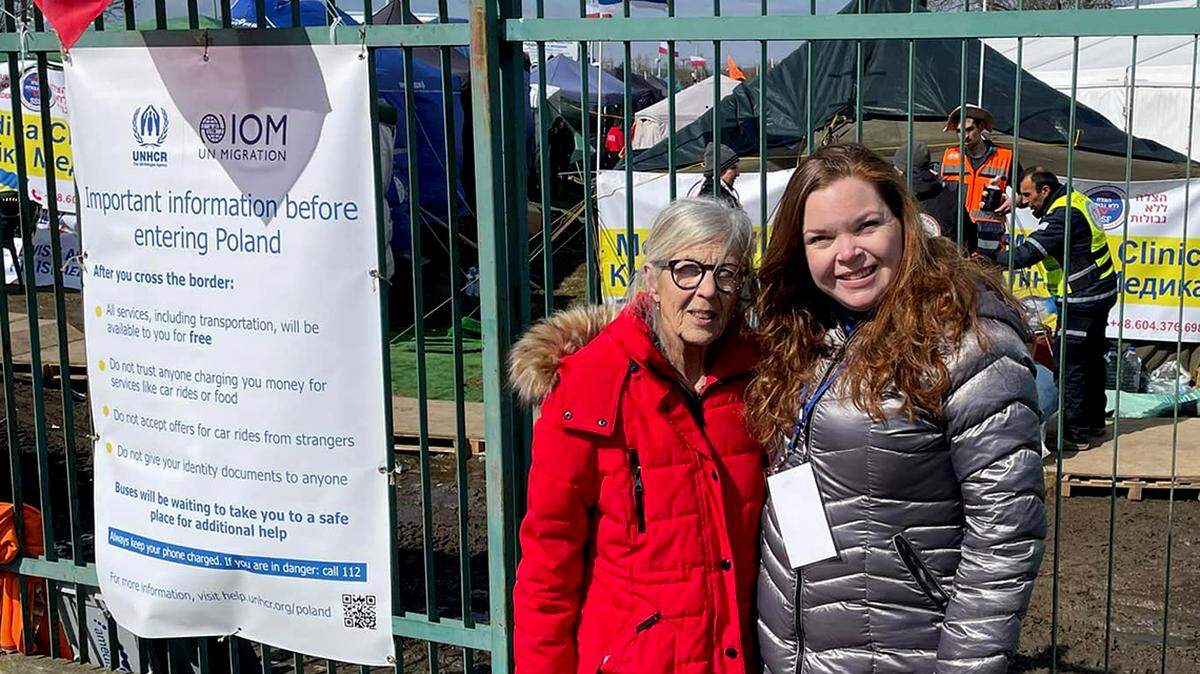 Nancy Burnett, advisory board chair of the Jewish Community Relations Council (left), and Lisa Long, the Youngstown Area Jewish Federation’s financial resource development director, pose for a photo while welcoming refugees at the Poland-Ukraine border in April 2022.