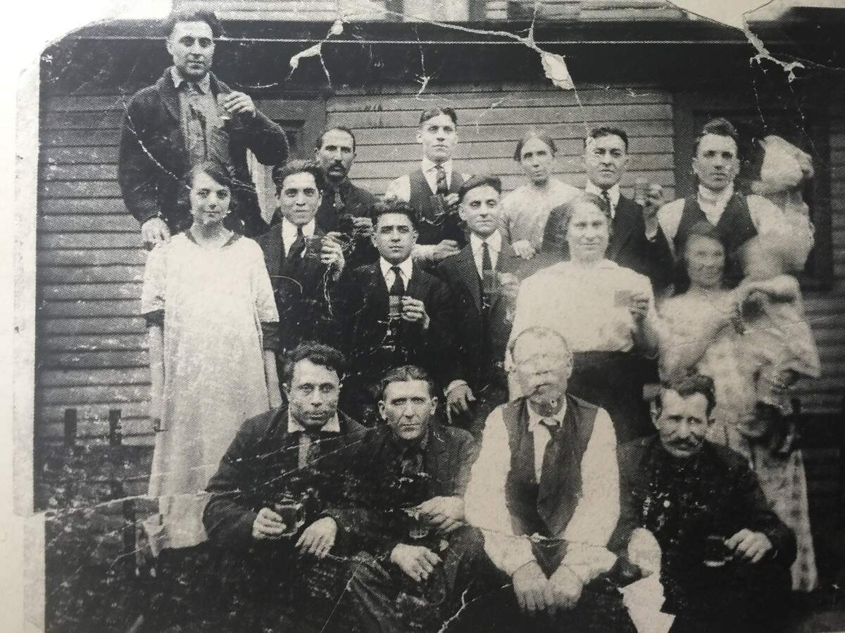 An old photograph of the Finamore and Donofrio family hangs on the wall at YOSTERIA, owned by Alex Zordich and Frank Tuscano. The families settled in Smoky Hollow from Italy and are cousins of Zordich.