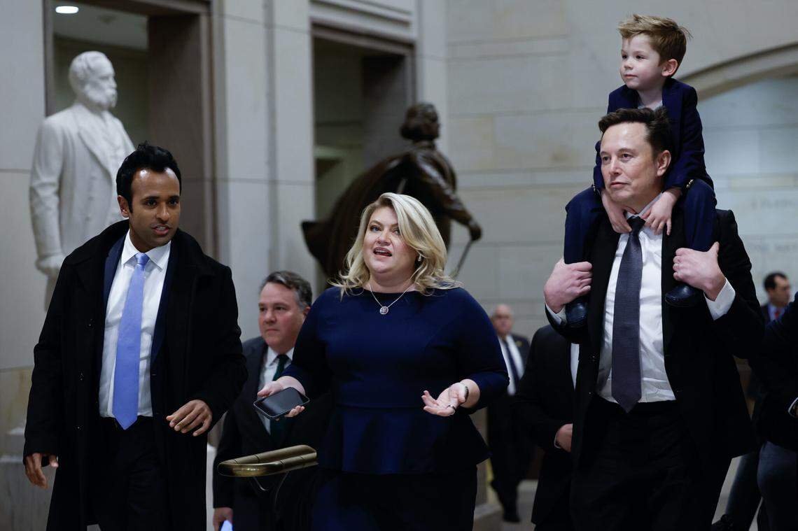 Tesla CEO Elon Musk , right, co-chair of the newly announced Department of Government Efficiency, carries his son on his shoulders at the U.S. Capitol following a meeting with businessman Vivek Ramaswamy, left, the other co-chair of the Department of Government Efficiency, Rep. Kat Cammack, center, and other members of Congress on Dec. 5, 2024 in Washington, D.C. Musk and Ramaswamy met with lawmakers about DOGE, a planned presidential advisory commission with the goal of cutting government spending and increasing efficiency in the federal workforce.