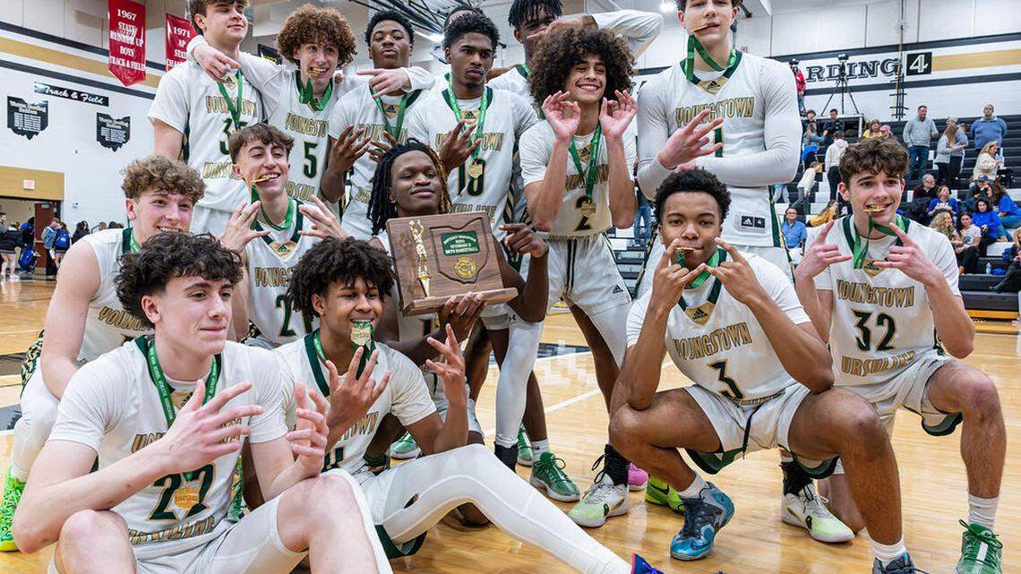 Ursuline boys basketball players celebrate their district title