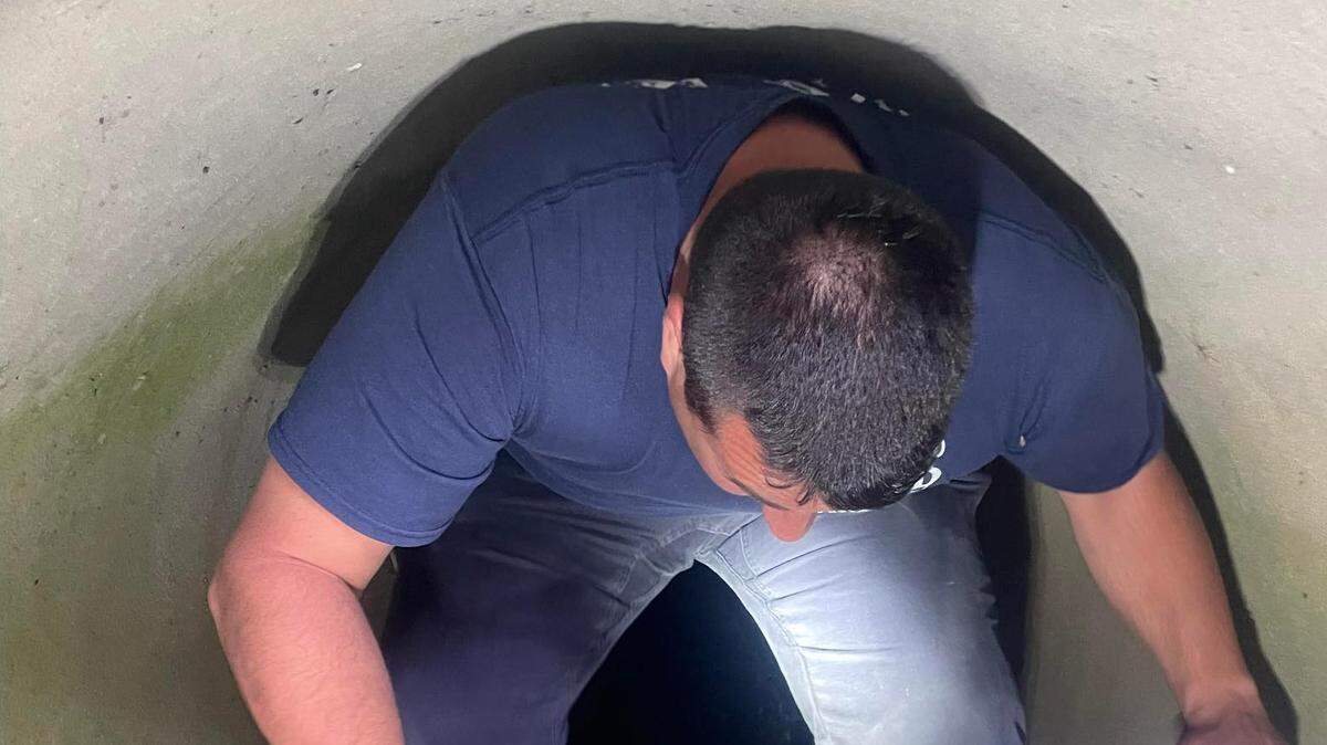 Holding the duck in the sewer is Howland Firefighter Paramedic Nate Durig