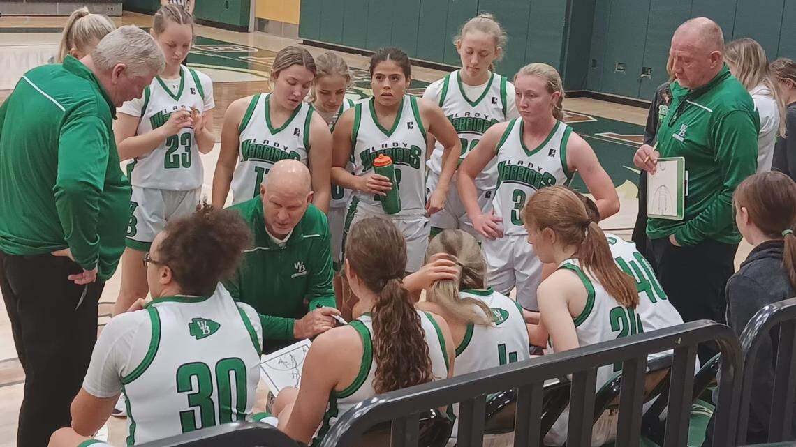 West Branch girls’ basketball coach Walt DeShields, bottom center, goes over strategy with his team in a timeout during their game against Olmsted Falls in the Wishes Can Happen Tournament hosted by GkenOak High School Thursday.