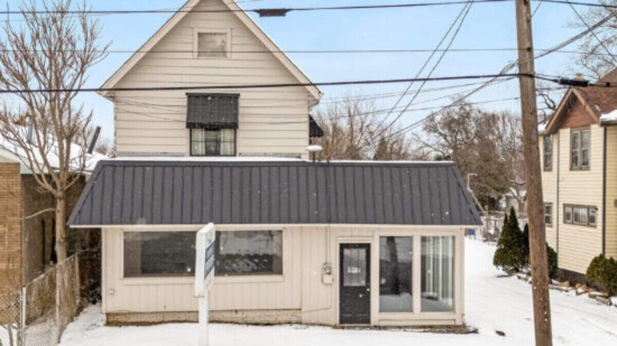 Available for $120,000, the 2,258-square-foot property has a second-floor apartment with a kitchen and full bathroom, walk-in cooler, heated garage and rear parking.