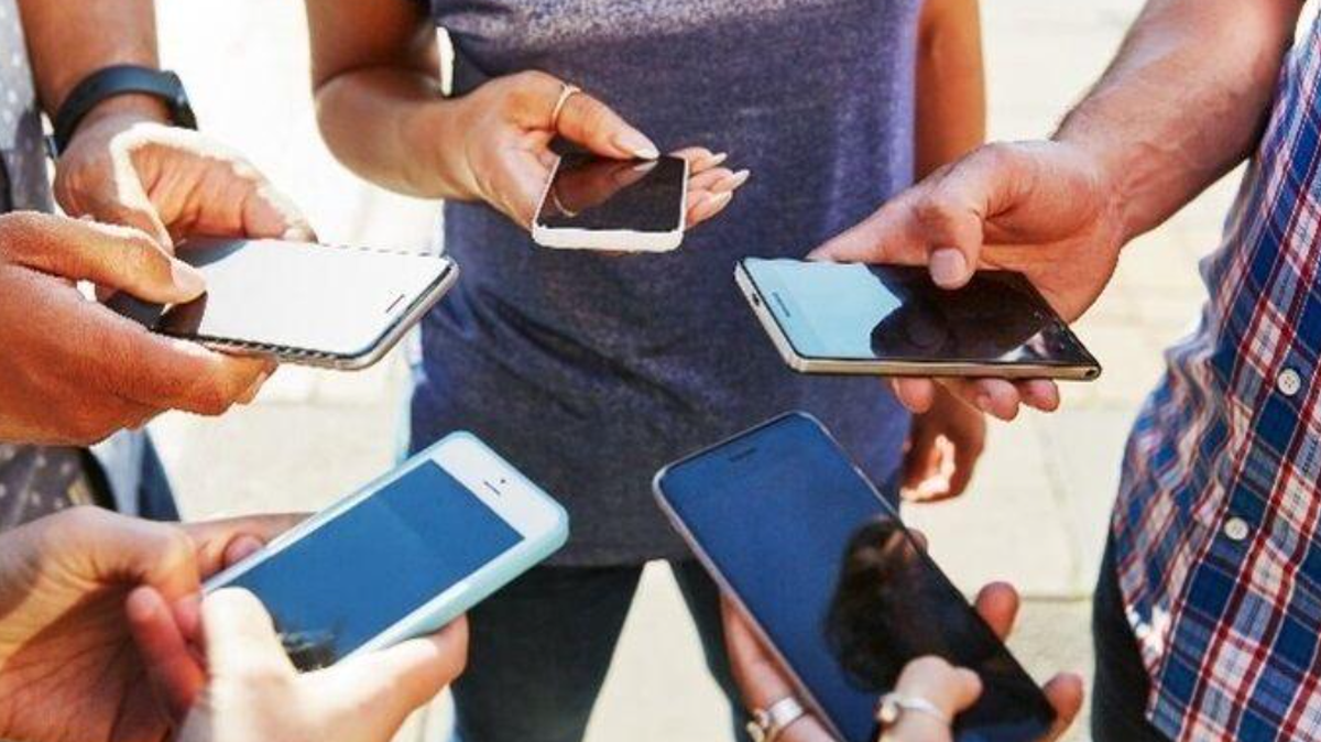 Users checking their social media on their cellphones. 