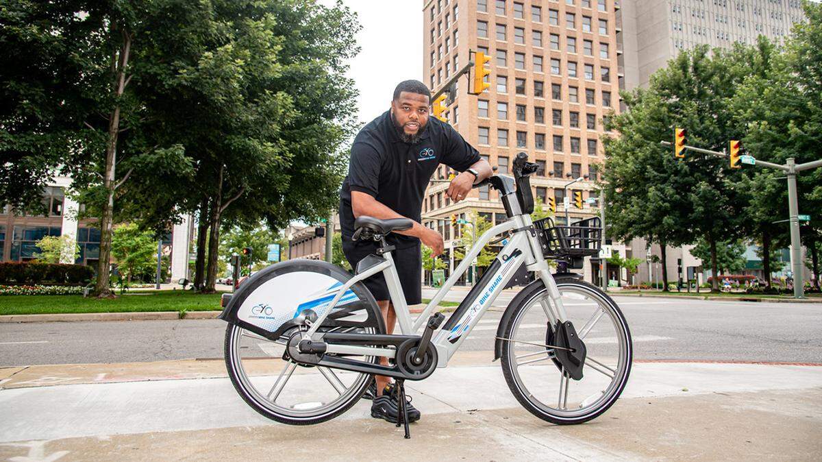 Ronnell Elkins, YoGo Bikeshare president, displays an e-bike in Youngstown. YoGo will install docking stations at four downtown Youngstown locations and launch its bike-share program in spring 2023.