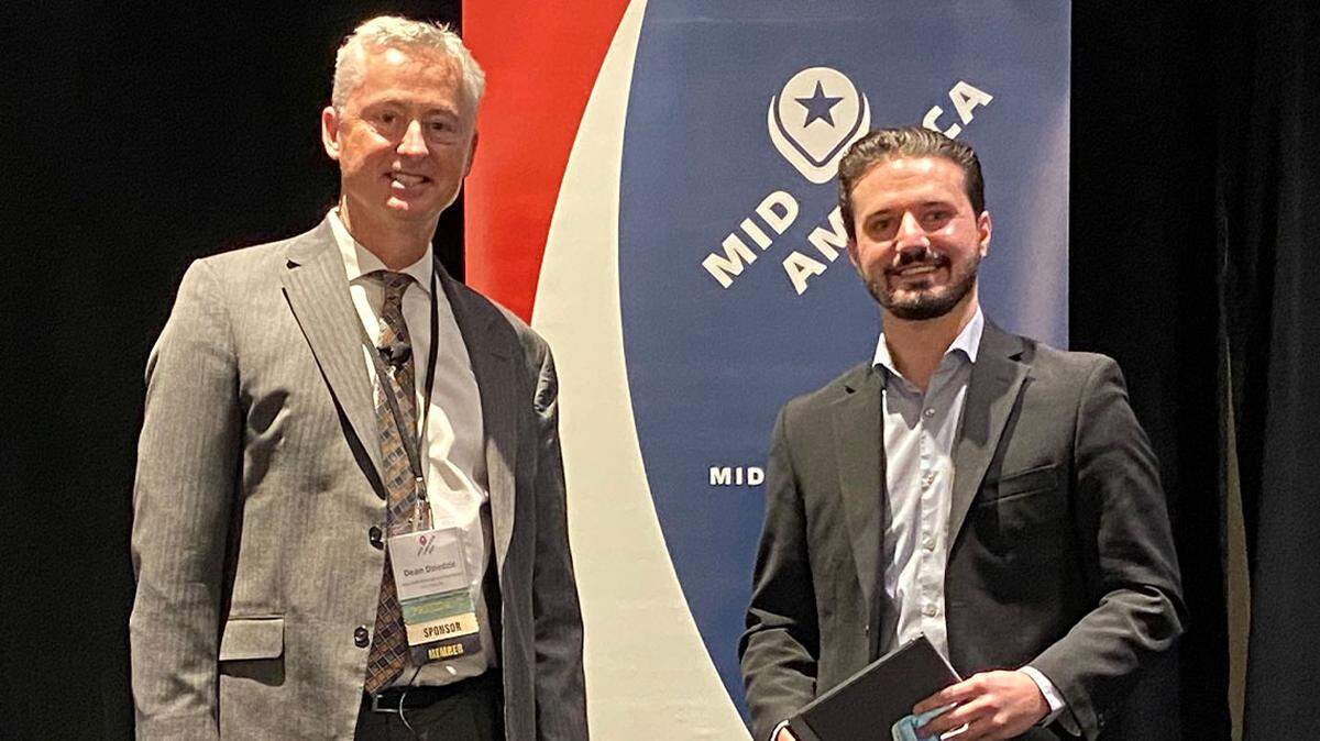 Shea MacMillan, right, the Youngstown/Warren Regional Chamber’s director of Economic Development Projects, attended the 2021 Mid-America Economic Development Council’s Competitiveness Conference in Chicago last week to accept the Economic Impact Deal of the Year Award. At left is Dean Dziedzic, Mid-America EDC board president. (Contributed photo)