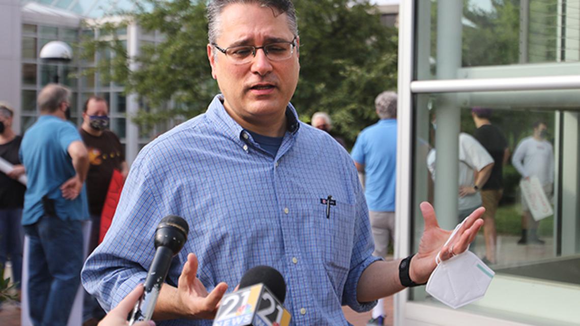 Mark Vopat, spokesperson for the Ohio Education Association’s Youngstown State University members, speaks to reporters during a protest against university administrators’ decision not to require masks for the 2021 fall semester on Friday, Aug. 13, 2021, outside Tod Hall.