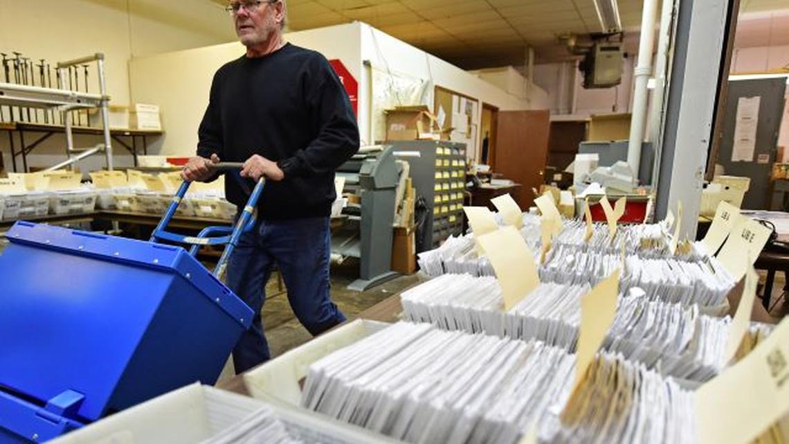 This Nov. 3, 2020, file photo shows Board of Elections worker Bob Moody moving boxes of ballots at the Trumbull County Board of Elections in Warren. (David Dermer | AP Photo, File)