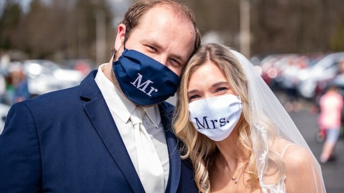 Alexis Benyo and Conor Chrystal of Austintown wore masks made by her grandmother for their a "social distancing" wedding reception on Saturday. (Shaun Jordan Photography).