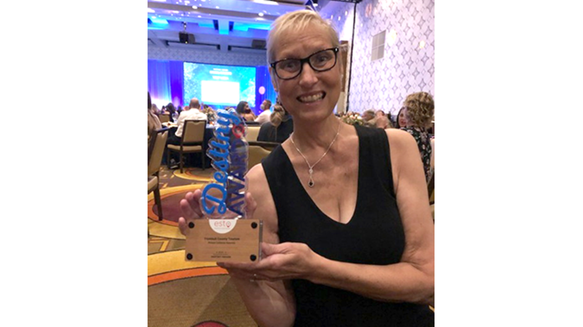Beth Carmichael, executive director of the Trumbull County Tourism Bureau, holds 2021 Destiny Award from the U.S. Travel Association, awarded Tuesday, Aug. 17, 2021 for the bureau's 2020 county visitors guide.