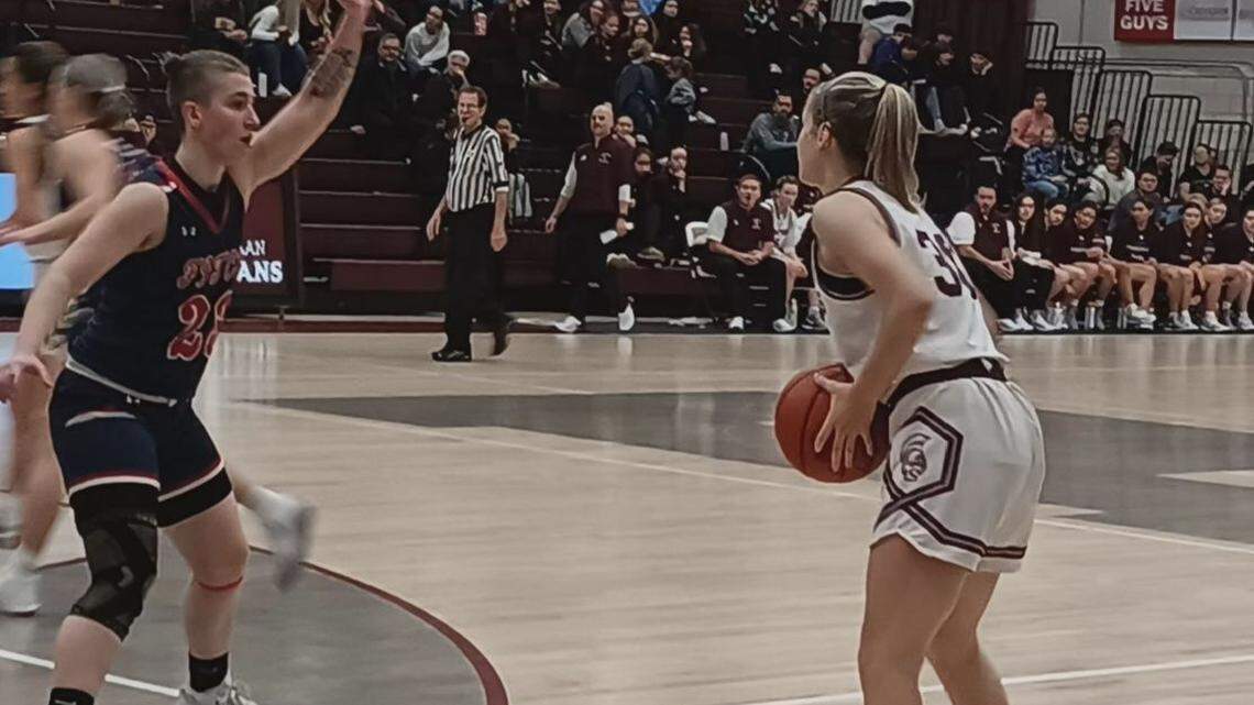 Boardman High School’s Mikayla Rivera, right, looks to pass the basketball inside as Austintown Fitch’s Lannie Henning, left, defends during Saturday’s All-American Conference girls’ basketball game at Boardman High School.