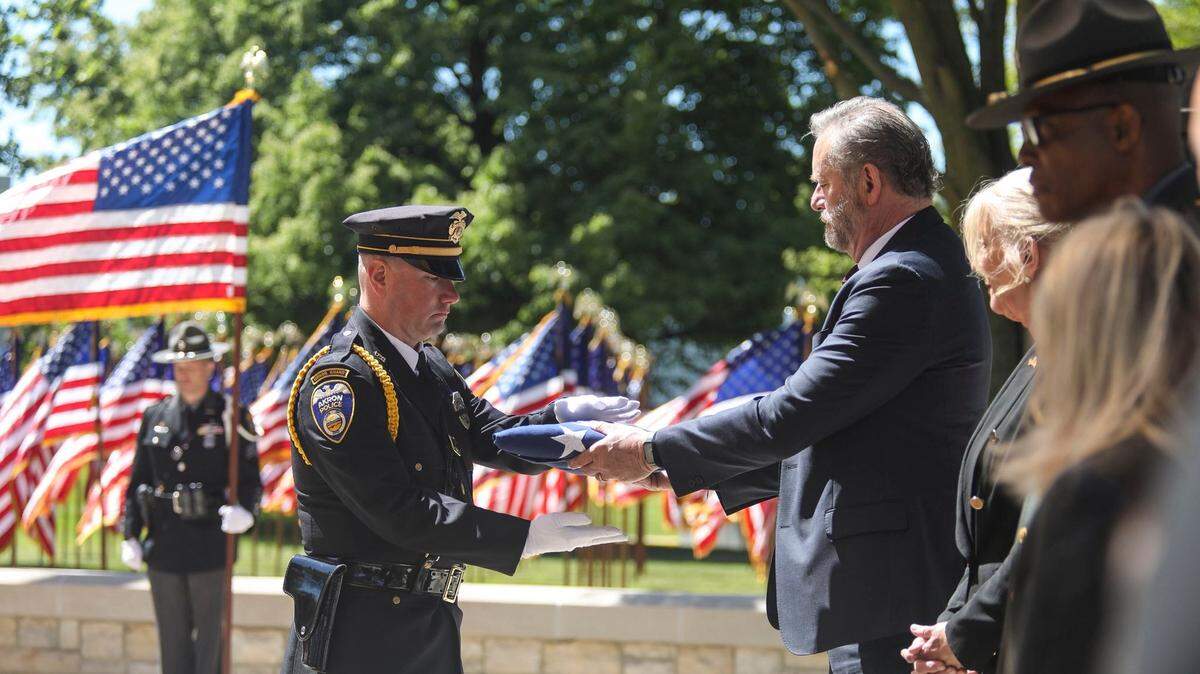 Attorney General Dave Yost and families honored four Ohio peace officers who died in the line of duty at the 38th memorial ceremony.