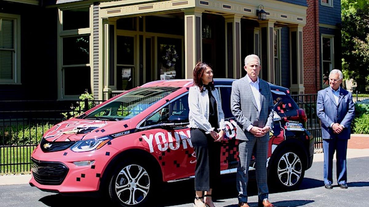 Alice and Greg Greenwood, from Greenwood Chevrolet and the Greenwood Foundation, stand with Youngstown State University President Jim Tressel in front of the Chevrolet Bolt that was donated to the university on Tuesday, March 18, 2021. (Ellen Wagner | Mahoning Matters)