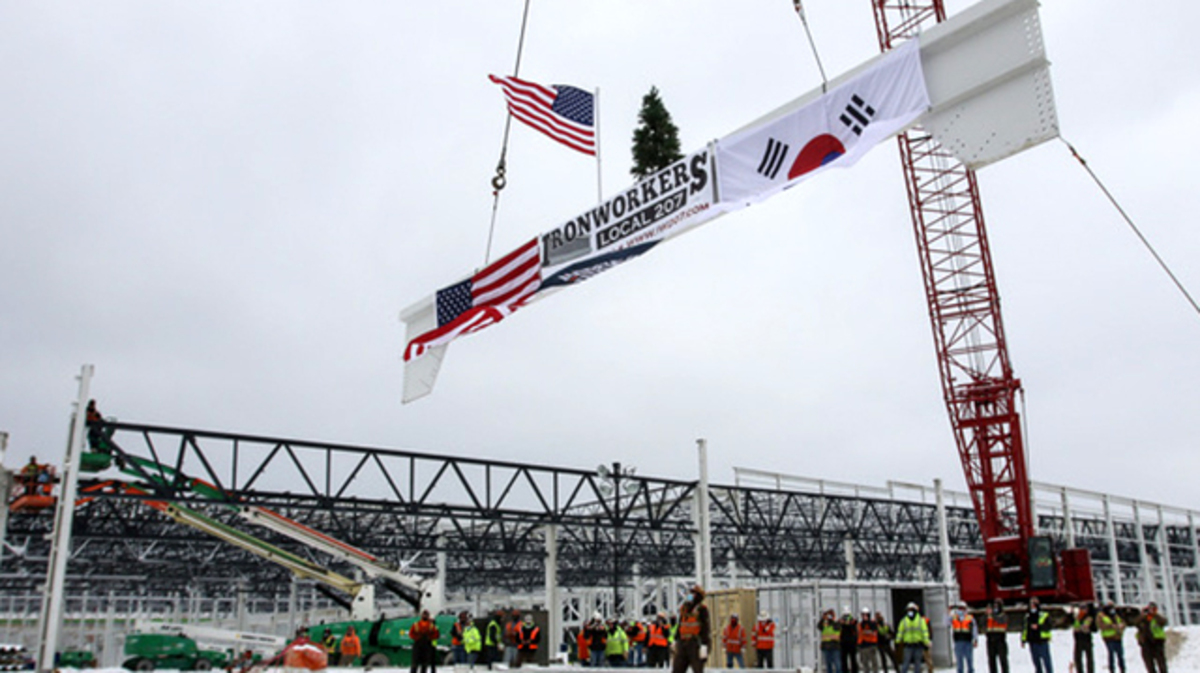 A crane hoists the final, ceremonial iron beam into place atop the steel skeleton of the incoming Ultium Cells LLC electric vehicle battery plant in Lordstown on Friday, Feb. 19, 2021. (Robert K. Yosay | Mahoning Matters)