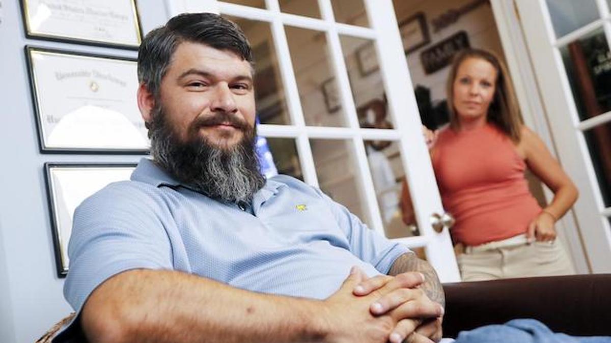 In this Aug. 11 photo, retired Lance Cpl. William Bee poses for a photo with his wife Bobby Jean surrounded by memories of his military service at his home in Jacksonville, N.C. 

