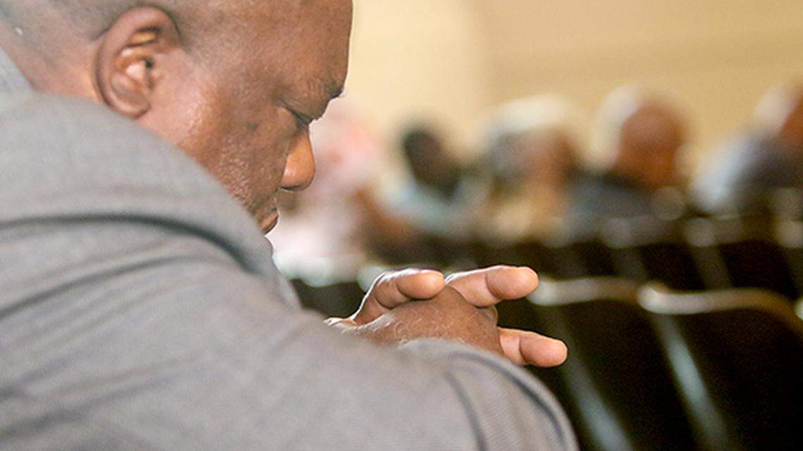 Joseph Walker, senior pastor of Restoration Christian Fellowship in Warren prays during a Trumbull NAACP-sponsored event about gun violence on Sunday, July 10, 2022, in Warren.