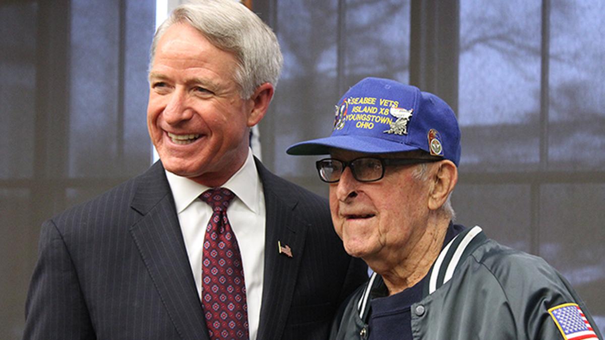 U.S. Navy Cmdr. Kirk Lippold (Ret.),  left, the commanding officer of the USS Cole when it was attacked by al Qaeda forces in October 2000, poses for a photo with Daryl "Jim" Duffett, 97, of Canfield, a U.S. Navy seabee who served in Iwo Jima during World War II. Lippold addressed dozens during a presentation on national security and foreign relations Wednesday at Canfield Public Library.