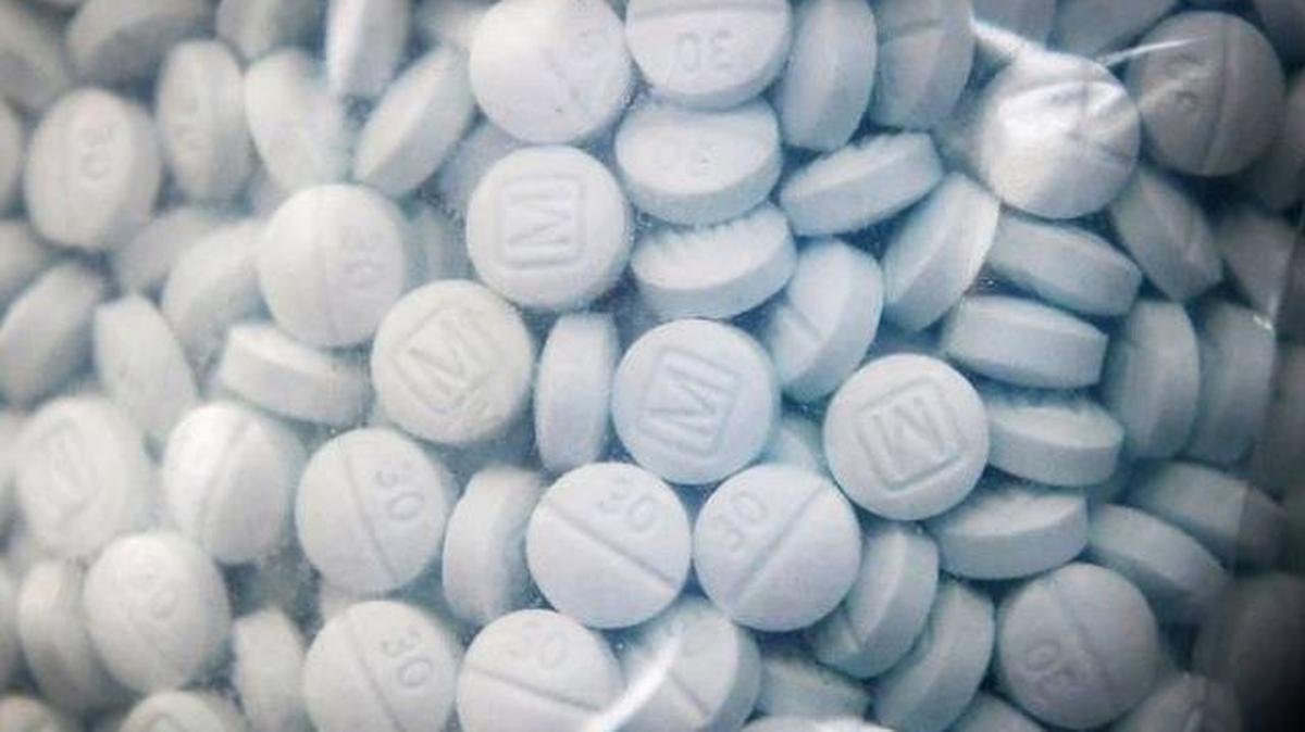 A bag of evidence containing the synthetic opioid fentanyl disguised as Oxycodone is shown during a press conference led by U.S. Attorney McGregor W. Scott at the Fresno County Sheriff’s Office on Aug. 19, 2020. (Craig Kohlruss | ckohlruss@fresnobee.com)
