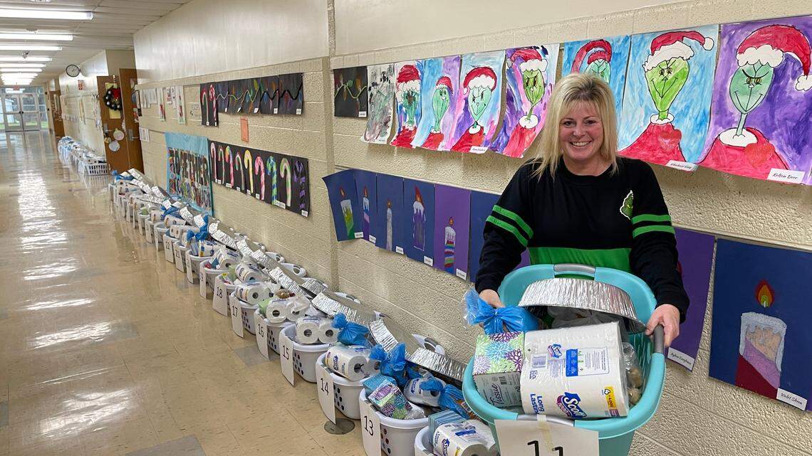 Sebring third-grade teacher Leann Laure poses with one of 53 baskets filled with household items and food for local families. She’s been leading the school’s annual Christmas drive for 29 years.