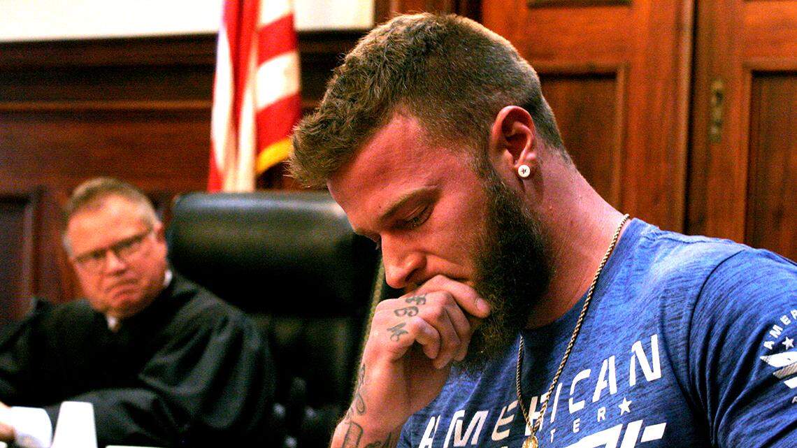 Joshua Ellis, a graduate of the Mahoning County Common Pleas Drug Court (right), pauses after receiving his diploma from Judge John M. Durkin (left) during a ceremony at the Mahoning County Courthouse in Youngstown, Ohio, on April, 27, 2022.
