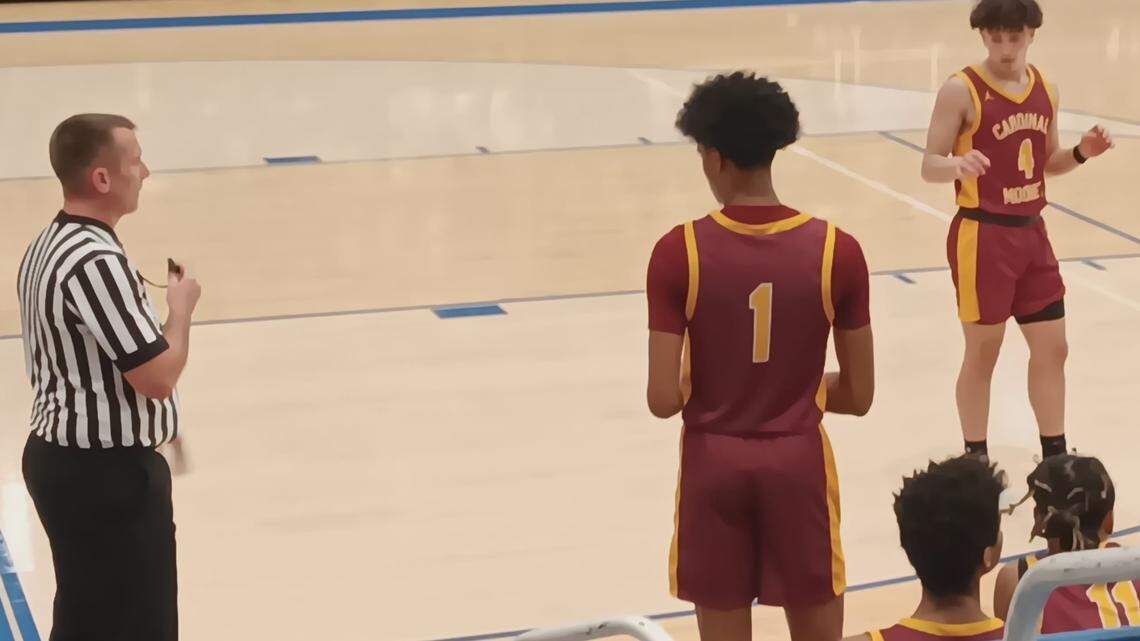 Youngstown Cardinal Mooney’s Eddie Nieves (1) prepares to inbound the basketball to teammate Nico Genova (4) as an official, left, looks on during Friday night’s varsity boys’ basketball game at East Liverpool. Mooney won the game, 66-51.