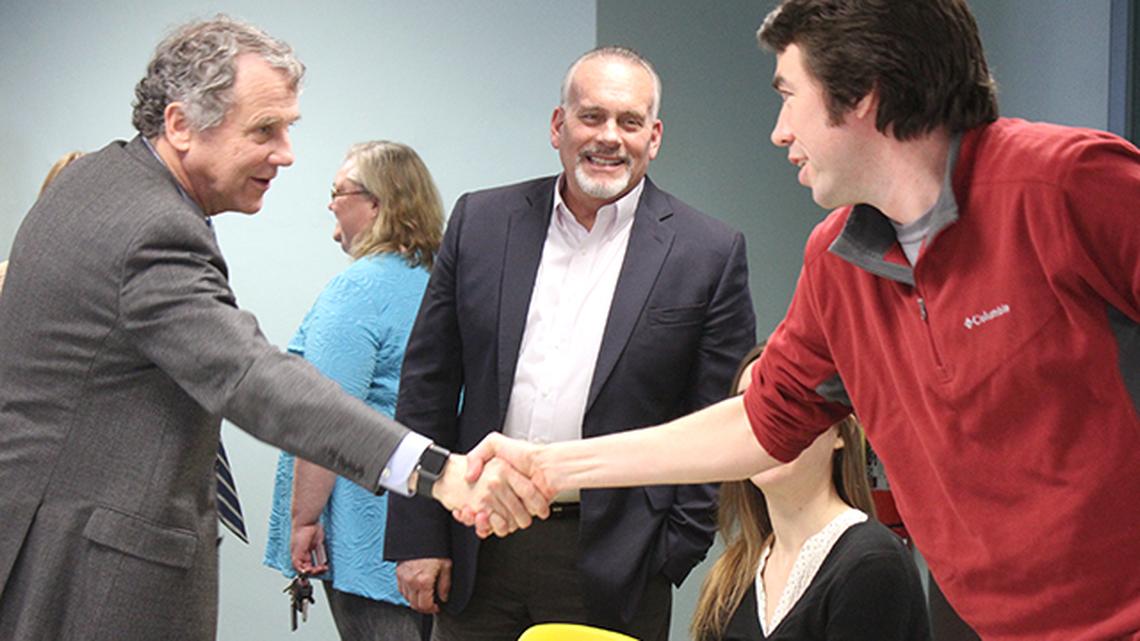 U.S. Sen. Sherrod Brown, D-OH, left, meets with with Ian Beniston, executive director of Youngstown Neighborhood Development Corporation, right, and Mike Durkin, Youngstown's code enforcement and blight remediation superintendent, center, prior to a roundtable on affordable housing Monday morning at the Public Library of Youngstown and Mahoning County. (Justin Dennis | Mahoning Matters)