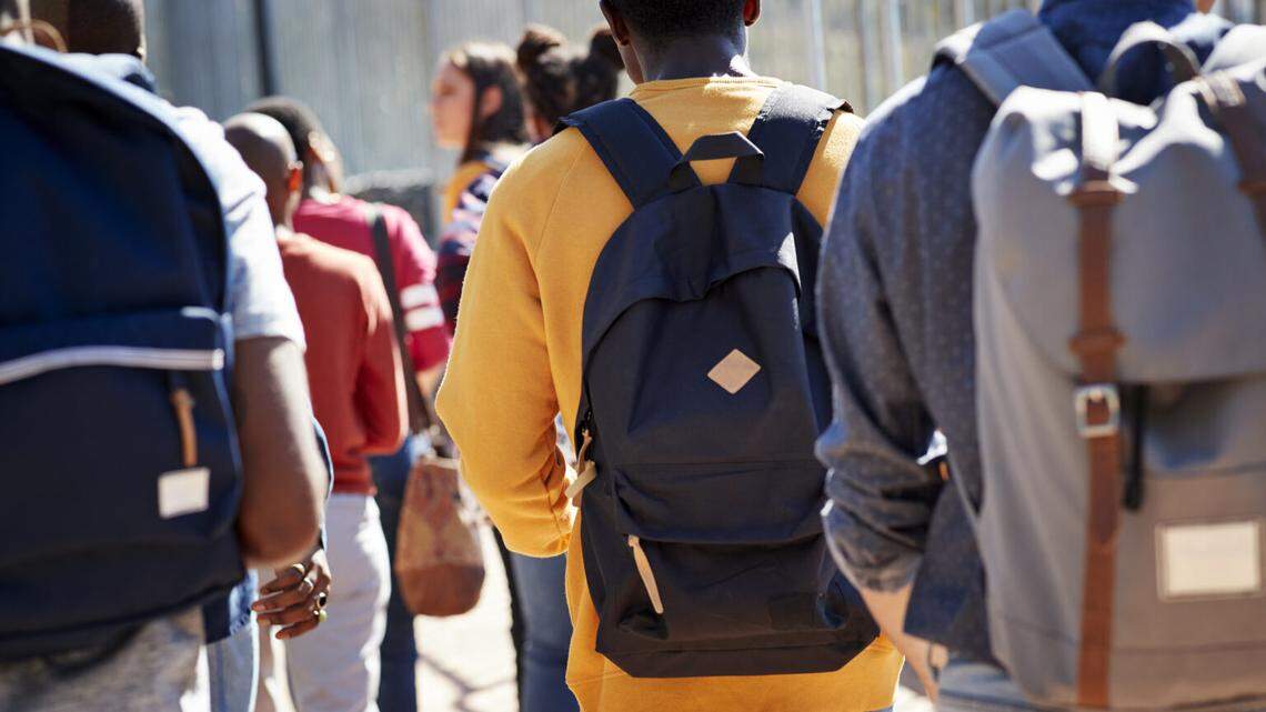 Students walking at campus during sunny day
