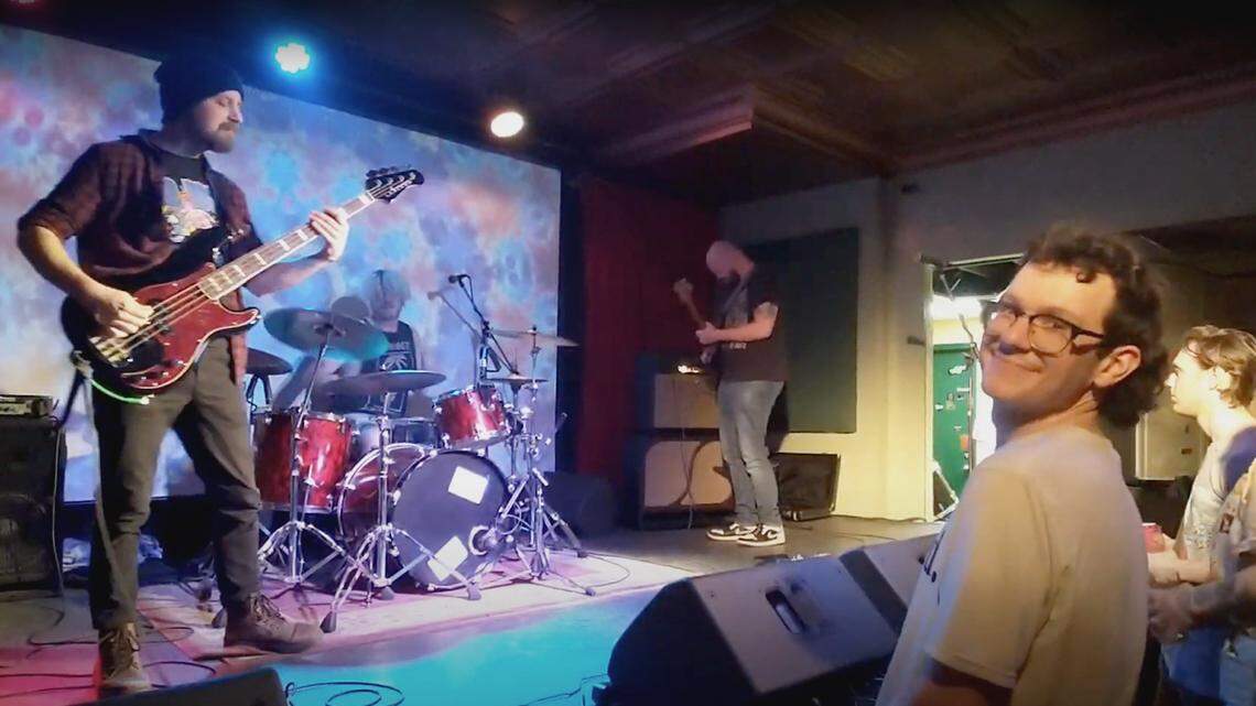Rock musicians performing on a multi-colored stage for a crowd in Youngstown, Ohio.