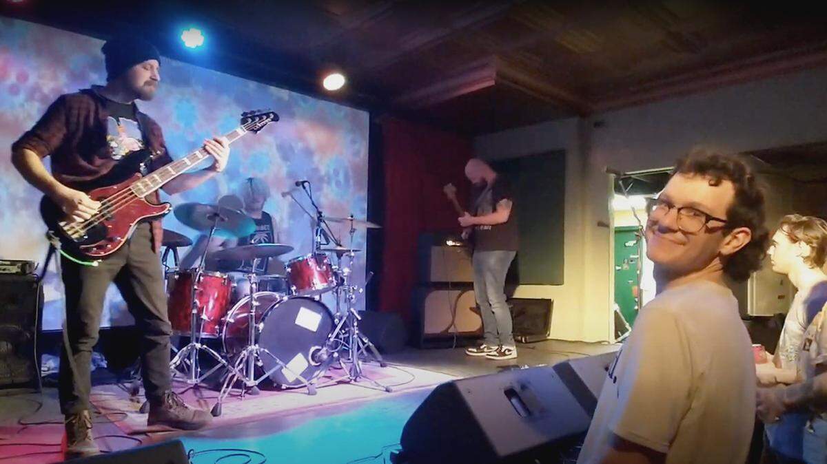 Rock musicians performing on a multi-colored stage for a crowd in Youngstown, Ohio.