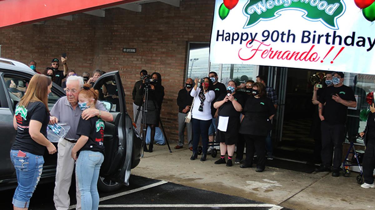 Wedgewood Pizza owner Fernando Riccioni (second from left) received a police escort to his Austintown restaurant, where he was greeted by his great nieces and well wishers who celebrated his 90th birthday on Wednesday, Nov. 11, 2020. (Robert K. Yosay | Mahoning Matters)