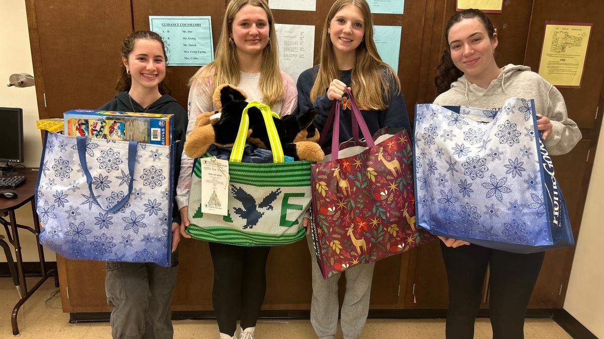 Boardman High School emerging leaders (left to right) Juliana Douglas, Lilly Scriber, Mackenzie Kelso and Jackie Andrews, holding their gift bags which will be donated to children in foster care.