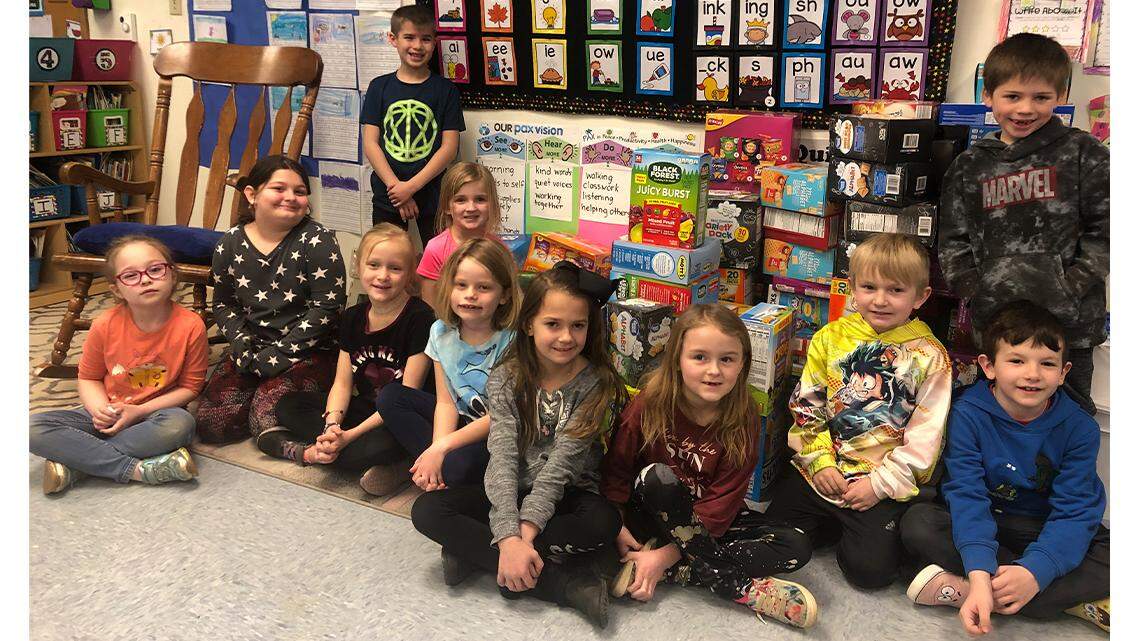 Students in Corinne Tomaino’s first-grade class at Jackson-Milton Elementary School are seen with some of the snacks they collected during their Snacks for Kids drive. The snacks were collected for children at the Rescue Mission of Mahoning Valley.