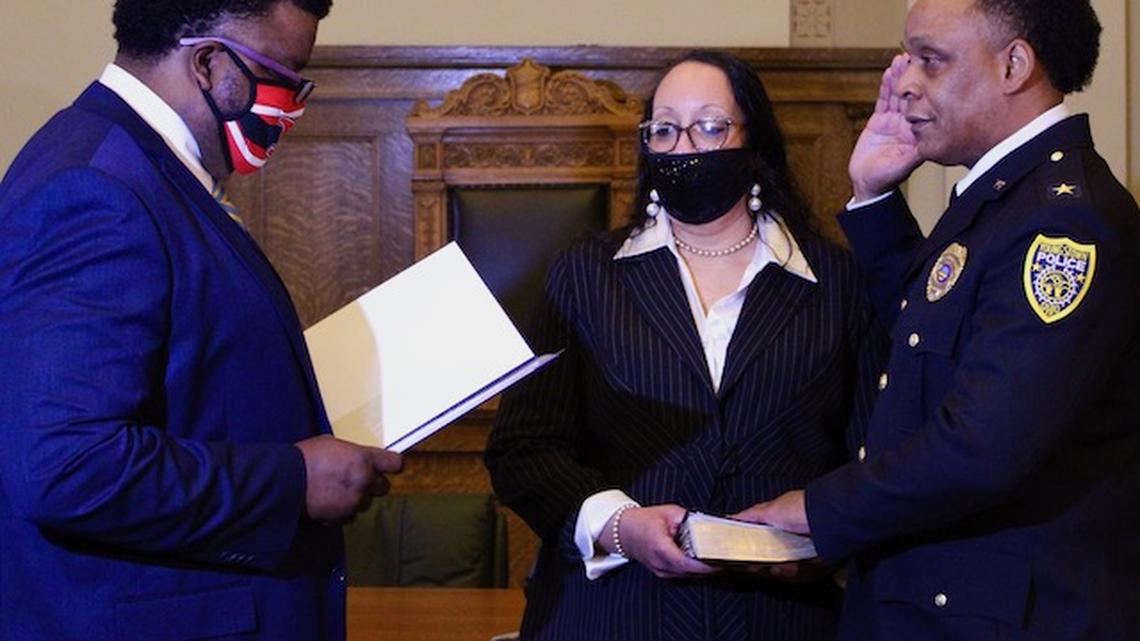 Carl Davis is sworn in as Youngstown Police Department chief by Mayor Jamael Tito Brown on Friday, Jan. 29, 2021. Kimberly Davis, the new chief's wife, holds the Bible during the ceremony. (Ellen Wagner | Mahoning Matters).