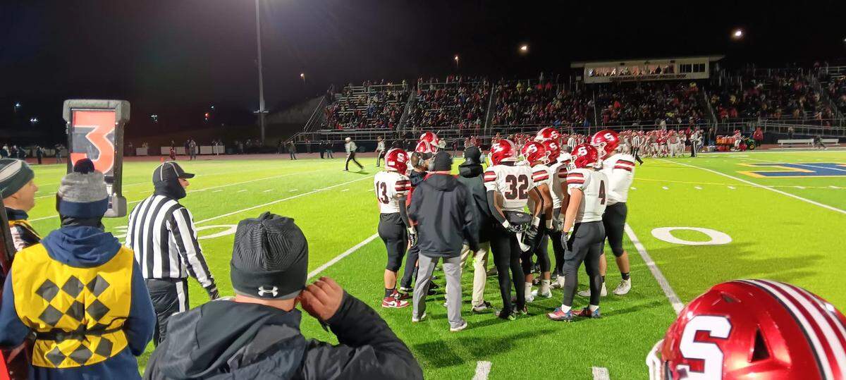 The Struthers’ offense listens to instructions from their coaches during a timeout in last weekend’s D4 football playoff game at Larry Bagnoli Stadium, a neutral field playoff site, in Tallmadge.