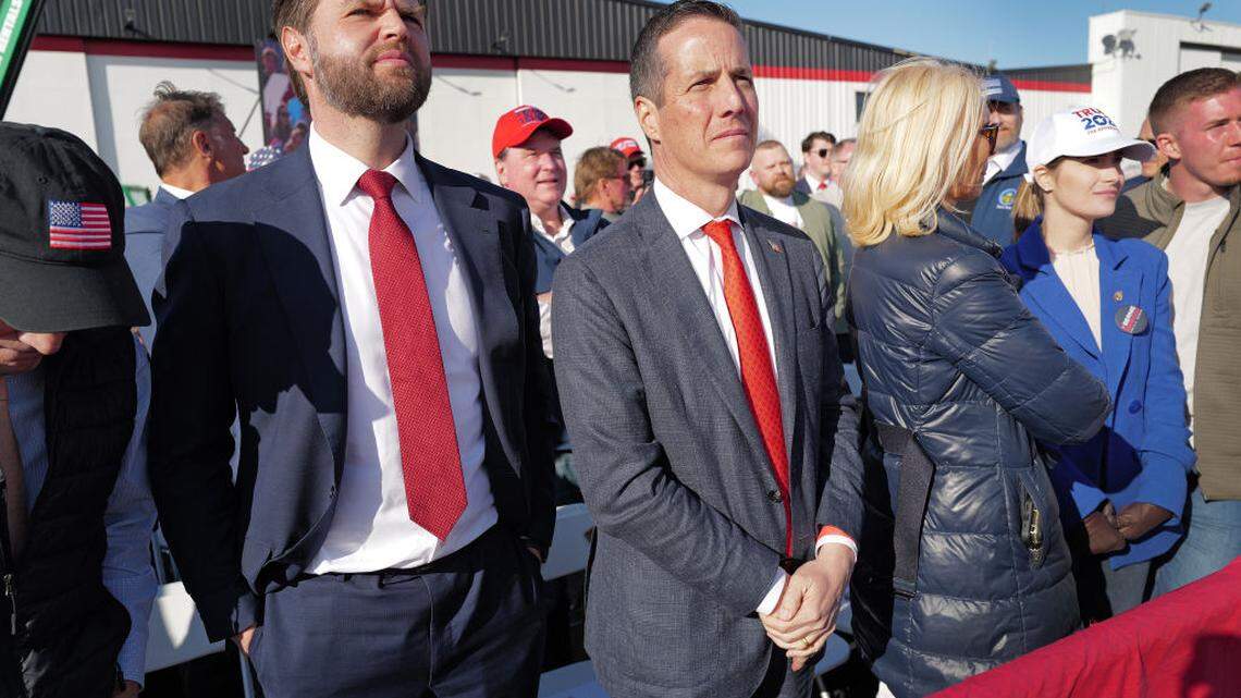 VANDALIA, OHIO - MARCH 16: U.S. Senator J.D. Vance (R-OH) (L) and Ohio Republican candidate for US Senate Bernie Moreno listen as Republican presidential candidate former President Donald Trump speaks during a rally at the Dayton International Airport on March 16, 2024 in Vandalia, Ohio. The rally was hosted by the Buckeye Values PAC. (Photo by Scott Olson/Getty Images)