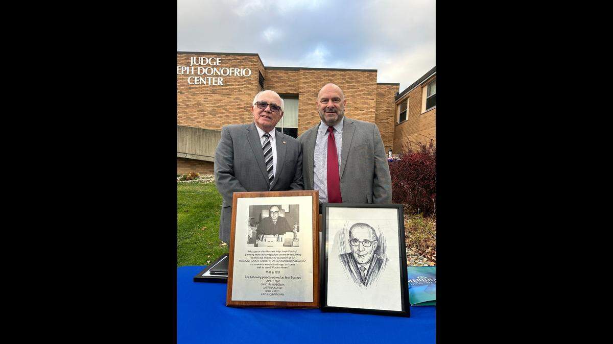 Gene Donofrio and Larry Moliterno smile for a photo at the unveiling of newly renamed Judge Joseph Donofrio Center.