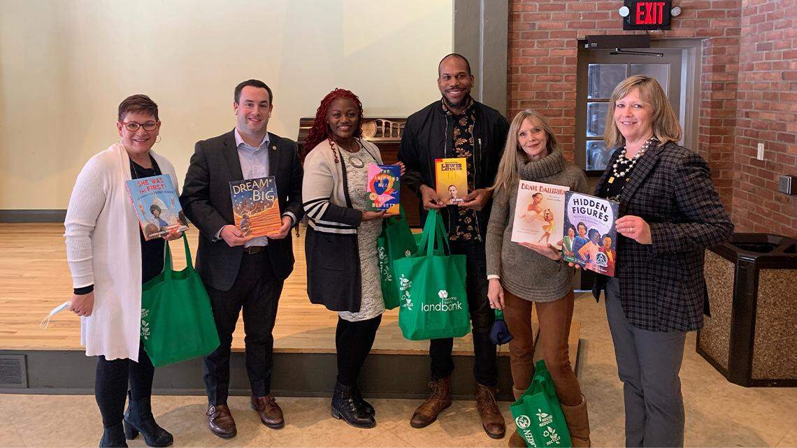 Volunteers take books to stock Little Free Libraries in Youngstown. From left are Aundrea Cika Heschmeyer; Josh Prest, Rotary Club of Youngstown president; Samantha Turner, the Rotary Club’s immediate past president; Derrick McDowell; Elayne Bozick; and Debora Flora.