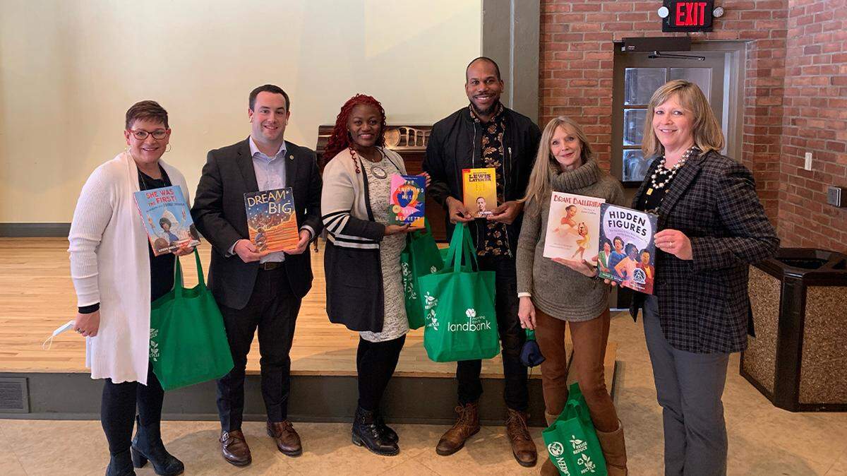 Volunteers take books to stock Little Free Libraries in Youngstown. From left are Aundrea Cika Heschmeyer; Josh Prest, Rotary Club of Youngstown president; Samantha Turner, the Rotary Club’s immediate past president; Derrick McDowell; Elayne Bozick; and Debora Flora.