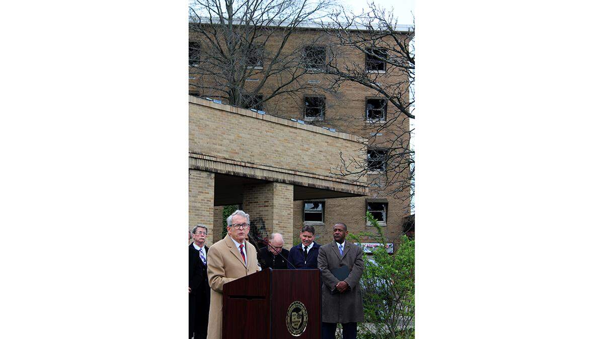 Gov. Mike DeWine speaks in front of the long-abandoned St. Joseph Riverside Hospital along Tod Avenue Northwest in Warren on Wednesday. The state recently awarded a $3.4 million grant to top off funding for its demolition.