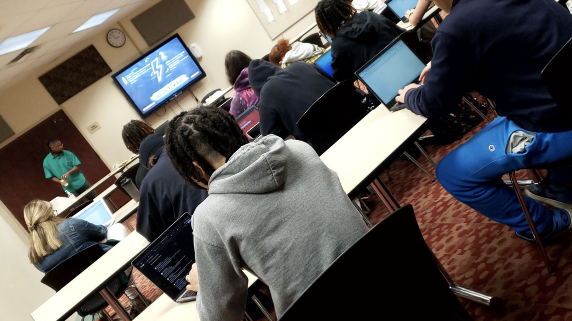 Quartez Harris leads Chaney High School’s Writing Fellows and students during the African American Read-In and Write-In class Wednesday at Chaney High School.
