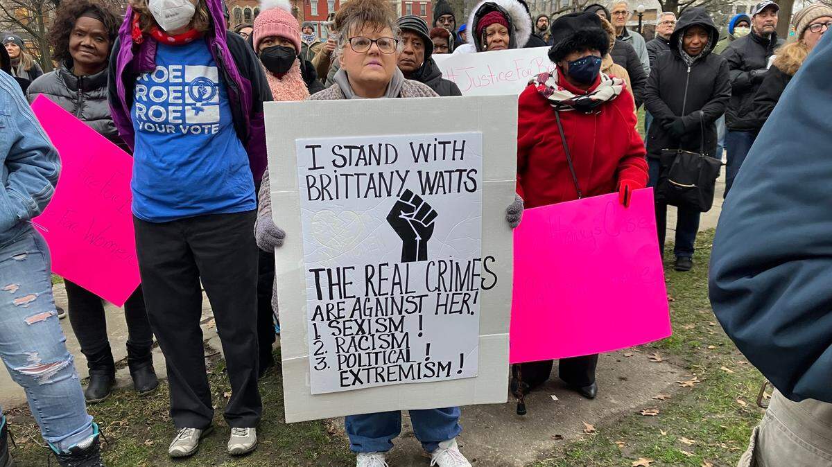 A Brittany Watts supporter holds a sign at a rally for her Thursday afternoon at Warren Courthouse Square.