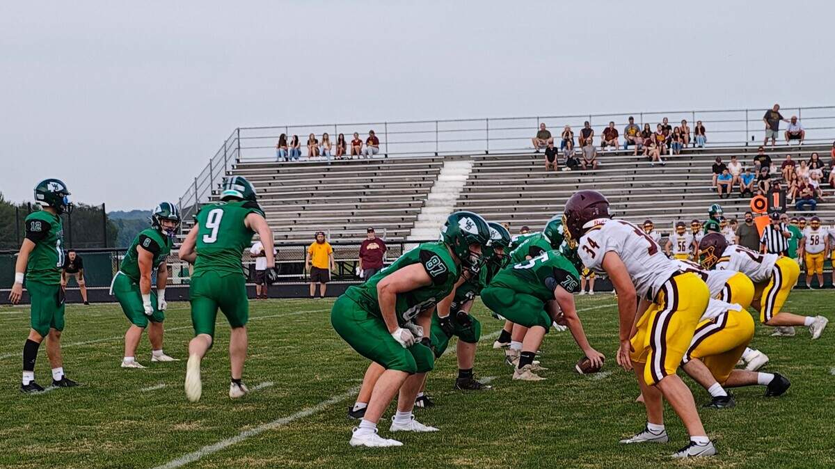 West Branch quarterback Jeremiah Thomas, left, prepares to take the shotgun snap as the South Range defense, right, gets set during Thursday night’s high school football scrimmage in Beloit.