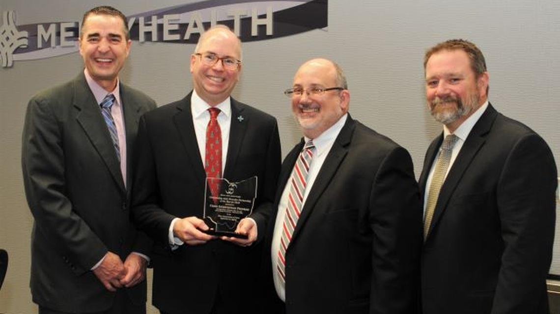 From left, Judge Robert N. Rusu Jr., Mahoning County Probate Court; Paul S. Homick Jr., president of Mercy Health Foundation Mahoning Valley; Joe Rossi, CEO of Direction Home of Eastern Ohio; and Douglas Doyle, crisis intervention and wellness manager of Direction Home of Eastern Ohio, display the Partner of the Year award presented to Mercy Health Foundation Mahoning Valley. (Contributed photo)