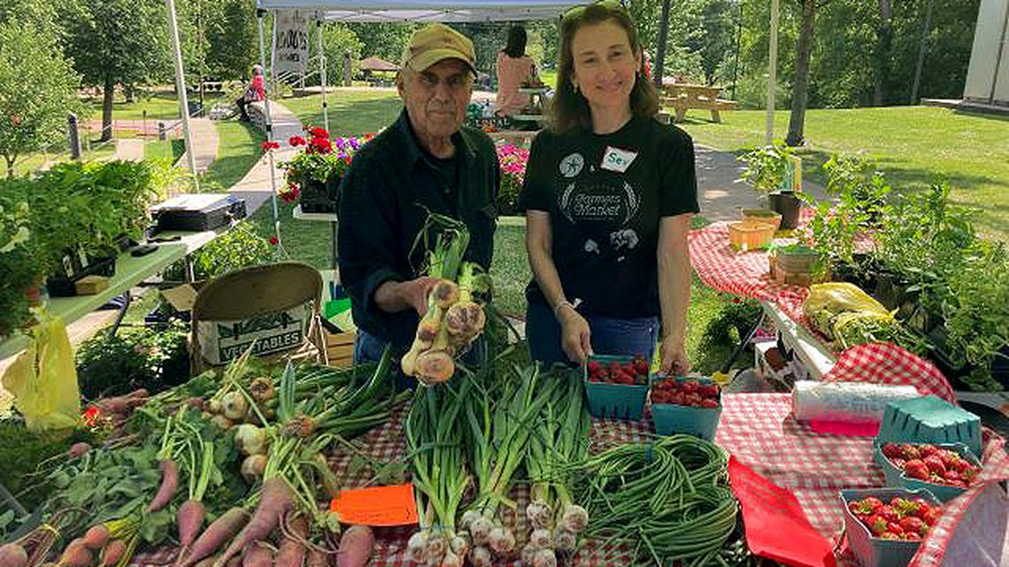 Sev Tripoulas, right, manager of the Warren Farmers Market, and Tony Santone of Sleepy Hollow Farm in Newton Falls show off some of the fresh fruits and vegetables available at the weekly market in Perkins Park. The Warren market is among seven that have teamed up to form the Mahoning Valley Farmers Market network to promote the benefits of these events. (Contributed photo)