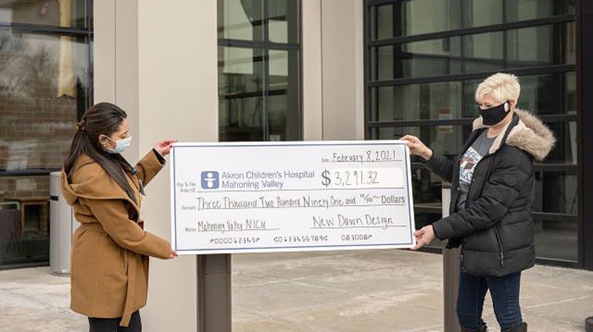 Linda Barton, founder of Sweet Memories Vintage Tees, right, presents a check to Jillian Chahine, Akron Children’s Hospital Foundation special projects coordinator. (Contributed photo)