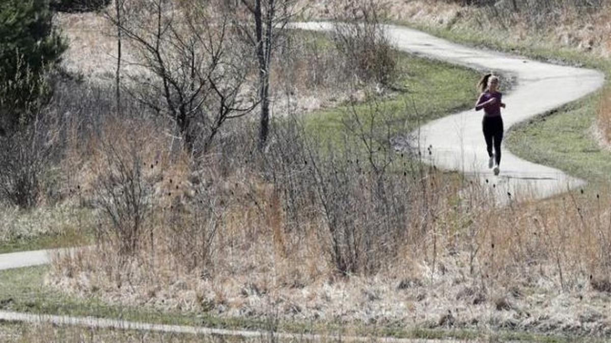 In this April 20, 2020, file photo, a woman jogs at Beachwood City Park West in Beachwood, Ohio. The state has lost one seat in Congress as a result of new census figures released Monday, marking the sixth straight decade of congressional declines for the state. (Tony Dejak | AP Photo)