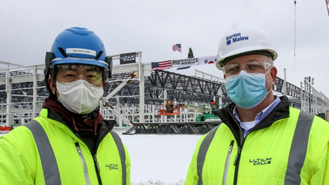 Tom Gallagher, director of Ultium Cells LLC's incoming electric vehicle battery plant (right), poses alongside his LG Chem counterpart, project Manager Michael Kim outside the under-construction plant, which saw its steel frame finished on Friday, Feb. 19, 2021. (Robert K. Yosay | Mahoning Matters)
