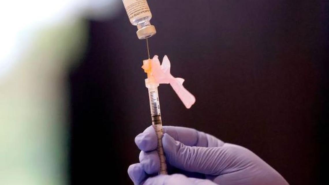 WakeMed pharmacist Michelle Cook prepares a Pfizer COVID-19 vaccine during the WakeMed Back-to-School Blitz vaccine clinic at the WakeMed Raleigh Campus in Raleigh, N.C., on Aug. 1. (Ethan Hyman | ehyman@newsoberserver.com)
